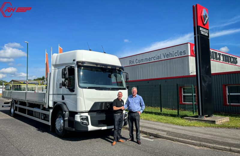 Simon and Mike infront of the new truck shaking hands